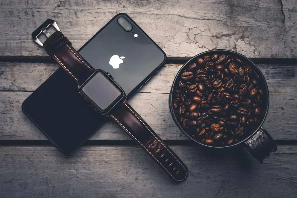 An Apple Watch resting on top of an iPhone