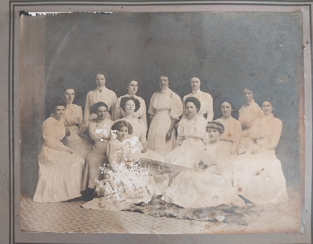 Damaged historical group photograph before restoration